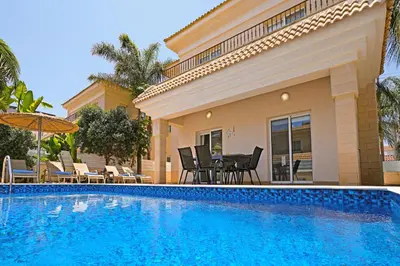 a swimming pool in front of a house at Villa Angelina - 300m from Kapparis beach in Paralimni