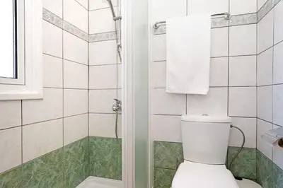 a bathroom with a toilet and a shower at Villa Angelina - 300m from Kapparis beach in Paralimni
