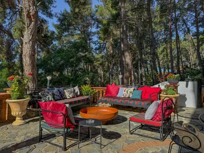 a patio with chairs and couches and a table at Semiramis Boutique Hotel & Spa in Kato Platres