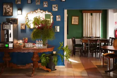 a dining room with a table and a mirror at Semiramis Boutique Hotel & Spa in Kato Platres