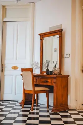 a wooden desk with a chair and a mirror at Semiramis Boutique Hotel & Spa in Kato Platres