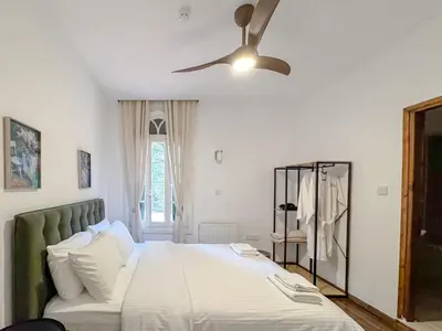 a bedroom with a bed and a ceiling fan at Semiramis Boutique Hotel & Spa in Kato Platres