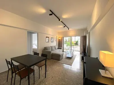 a living room with a table and a couch at Cozy 1 BDR in Nicosia city center - Aiantos By Platform 357 in Strovolos