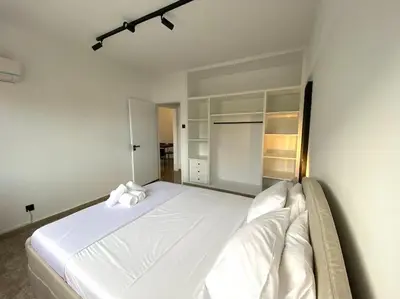 a bedroom with a large white bed in a room at Cozy 1 BDR in Nicosia city center - Aiantos By Platform 357 in Strovolos