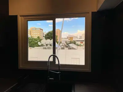 a window with a view of a city at Cozy 1 BDR in Nicosia city center - Aiantos By Platform 357 in Strovolos