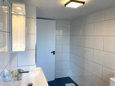 a white bathroom with a sink and a shower at Cozy 1 BDR in Nicosia city center - Aiantos By Platform 357 in Strovolos