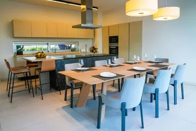 a kitchen with a large wooden table and chairs at Royal Oasis Villa in Ayia Napa