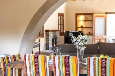 a dining room with a table with colorful chairs at Troodos Mature Pine Chalet in Pedoulas