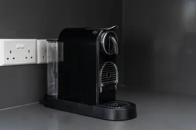 a black coffee maker sitting on top of a counter at Mediterranean Oasis Protaras in Protaras