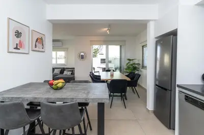 a kitchen and dining room with a table and chairs at Mediterranean Oasis Protaras in Protaras