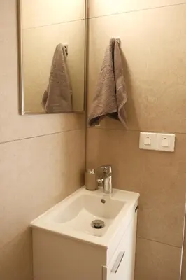 a bathroom with a sink and a mirror at Mediterranean Oasis Protaras in Protaras