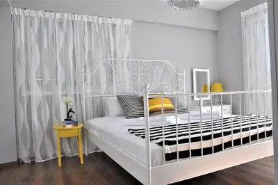 a bedroom with a white bed with a white canopy at Liliana Sea View Suite in Larnaka