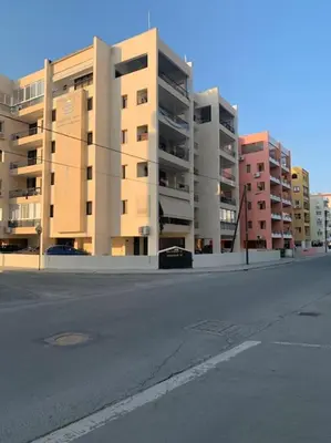 an empty street in front of tall buildings at Antonia Sea View Suite in Larnaka