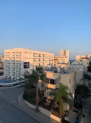 a view of a city with buildings and palm trees at Antonia Sea View Suite in Larnaka