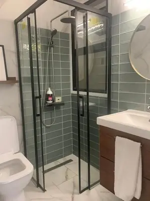 a bathroom with a shower and a toilet and a sink at Antonia Sea View Suite in Larnaka