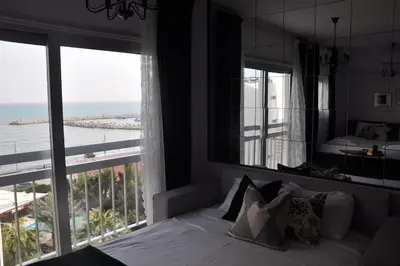 a bedroom with a bed with a view of the ocean at Aria Sea View Studio in Larnaka