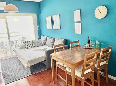 a living room with a table and a couch at Emma Sea View Suite in Larnaka