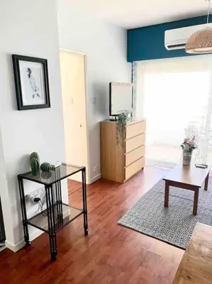 a living room with a glass table and a tv at Emma Sea View Suite in Larnaka