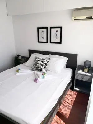 a bedroom with a large bed with white sheets and pillows at Emma Sea View Suite in Larnaka