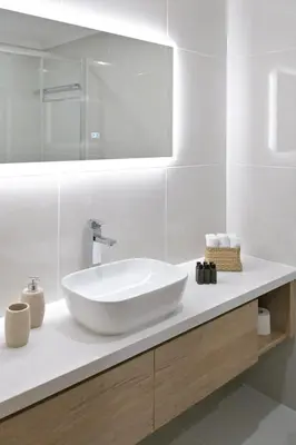 a white bathroom with a sink and a mirror at Oikou Thea Guesthouse in Oikos