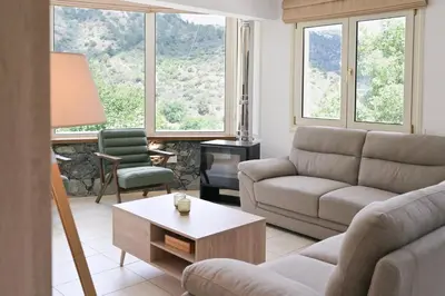 a living room with a couch and a coffee table at Oikou Thea Guesthouse in Oikos