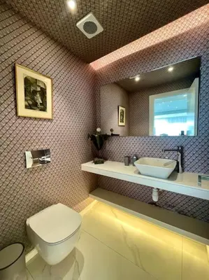 a bathroom with a toilet and a sink and a mirror at Penthouse Luxury Apartment in Nicosia