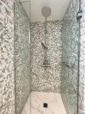 a bathroom with a shower with a glass door at Penthouse Luxury Apartment in Nicosia