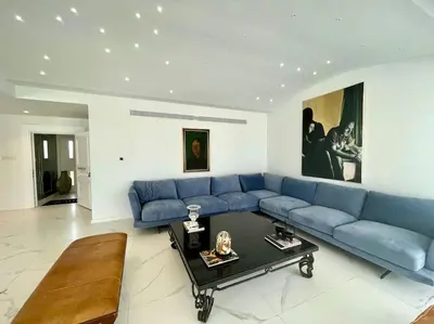 a blue couch in a living room with a table at Penthouse Luxury Apartment in Nicosia