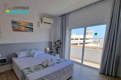 a bedroom with a bed with two teddy bears on it at Kitieos Central Apts 100m from Finikoudes Beach in Larnaka