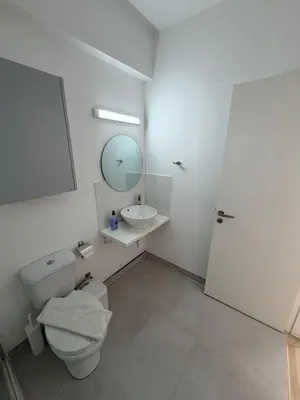 a bathroom with a toilet and a sink and a mirror at Kitieos Central Apts 100m from Finikoudes Beach in Larnaka