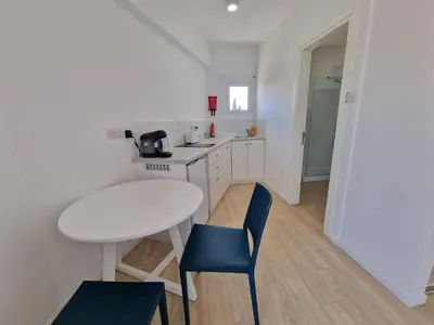 a small kitchen with a white table and chairs at Kitieos Central Apts 100m from Finikoudes Beach in Larnaka