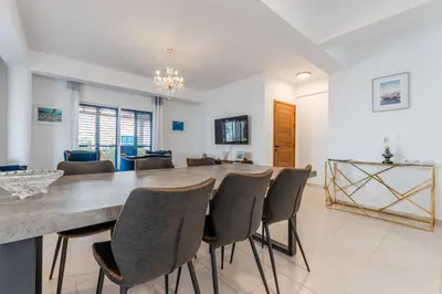 a dining room with a large table and chairs at Seaview Sanctuary House in Larnaka