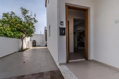 an open door of a white building with a hallway at Seaview Sanctuary House in Larnaka