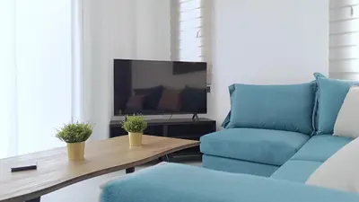 a living room with a couch and a tv at Larvella Estia Luxury Suites in Larnaka