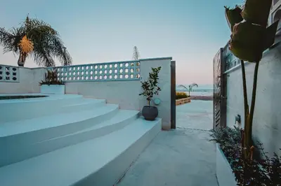 a set of stairs leading to a house with a view of the ocean at Q Coconuts Seaside Suites in Limassol