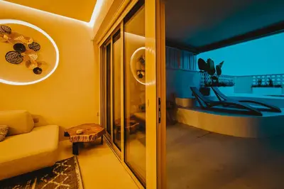 a living room with a yellow couch and a table at Q Coconuts Seaside Suites in Limassol