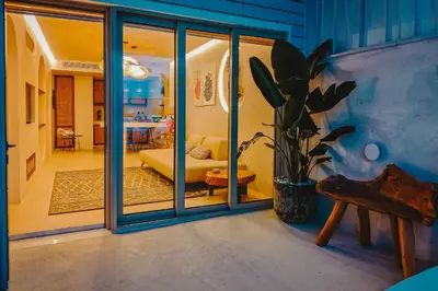 a living room with a couch and a potted plant at Q Coconuts Seaside Suites in Limassol