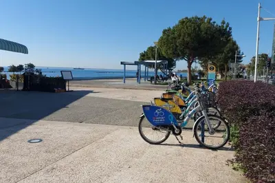 a bike parked on a sidewalk near the beach at Tourist Hot Spot Location in Limassol