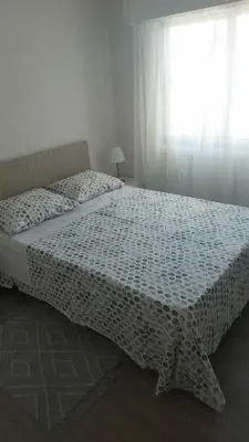 a bed in a white bedroom with a window at Tourist Hot Spot Location in Limassol
