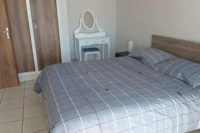 a bedroom with a bed and a mirror on a table at Peaceful Beach Location in Limassol