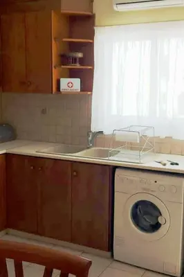 a kitchen with a washing machine and a sink at Balcony Sea View Whole Apt, Minutes To Beach in Limassol