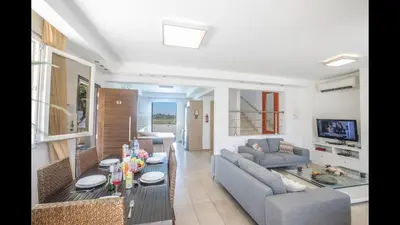 a living room with a couch and a table at Protaras Katerina Villa Kv53 in Paralimni