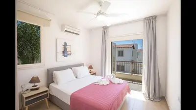 a bedroom with a bed and a large window at Protaras Katerina Villa Kv53 in Paralimni