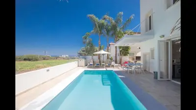 a swimming pool in the backyard of a house at Protaras Katerina Villa Kv53 in Paralimni
