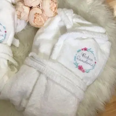 a white baby outfit with flowers on it at PROTEA RESIDENCE with private terrace in Nicosia