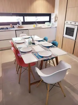 a table in a kitchen with chairs and a table and chairsktop at PROTEA RESIDENCE with private terrace in Nicosia
