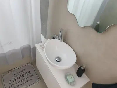 a bathroom with a white sink and a mirror at PROTEA RESIDENCE with private terrace in Nicosia