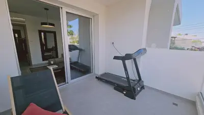 a room with a gym with a treadmill and a window at STAY Digital Den Apartment in Larnaka