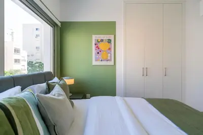 a bedroom with a bed and a green wall at Hazel - 2-Bedroom Apartment in Larnaca in Larnaka