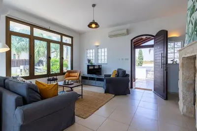 a living room with two couches and a fireplace at Lumina 2-Bedroom Villa and Pool in Ayia Napa in Ayia Napa